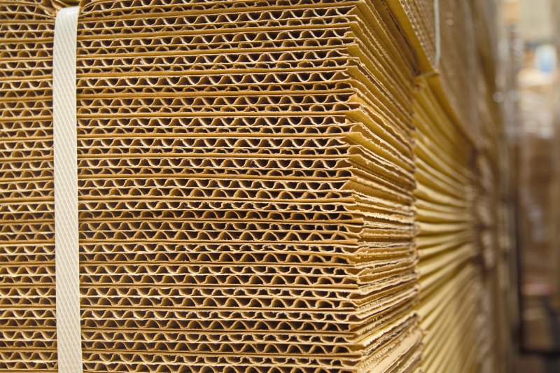 A stack of corrugated cardboard in a factory